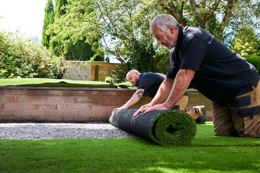 Two people setting up turf for a house in Las Vegas, NV
